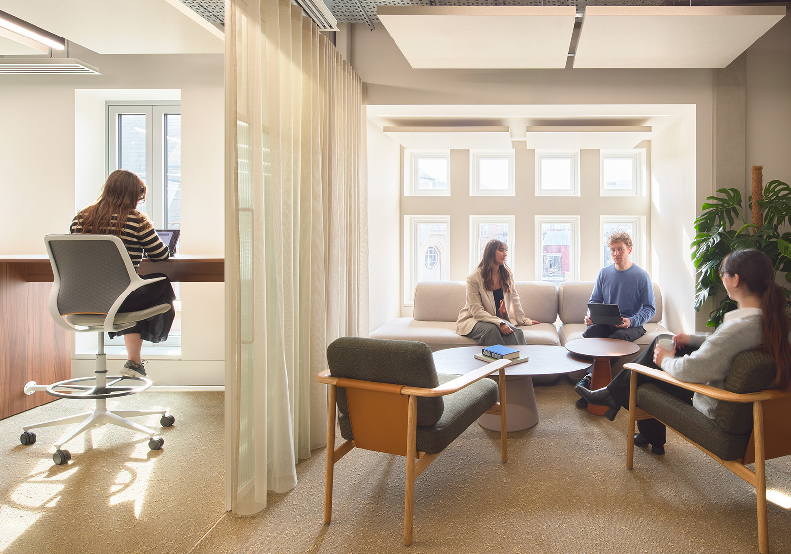 Staff working in an open-plan workstation at Gleeds London HQ featuring Acoufelt Acoustic Ceiling Panels