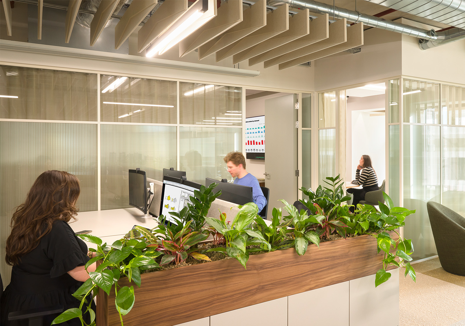 Staff working in an open-plan workstation at Gleeds London HQ featuring Acoufelt Acoustic Ceiling Baffles