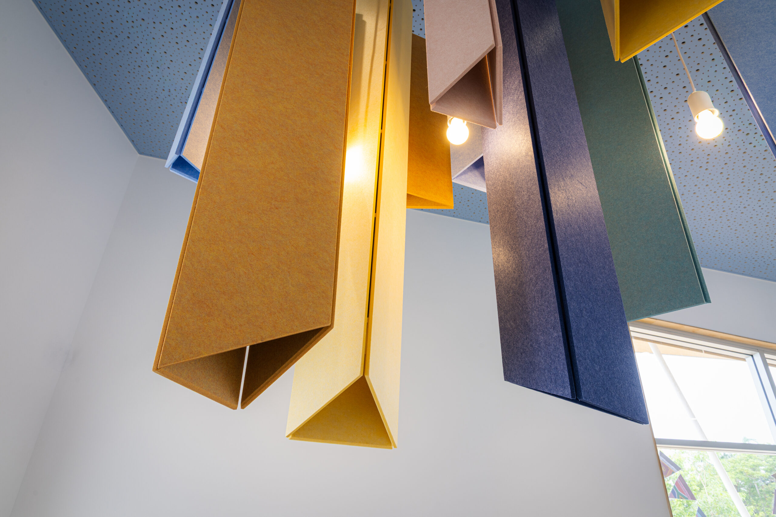 Acoufelt Pendant Ceiling Clouds in Periwinkle, Sea Salt, Turmeric, Valentine, Granite and Wheat installed in Parap Preschool
